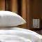 A serene bedroom scene with soft lighting, fresh linens, and an open book, suggesting restful sleep.