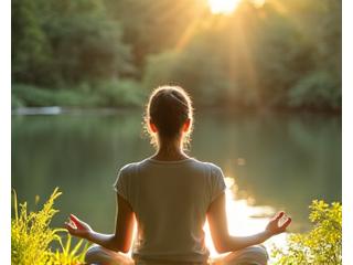 Person meditating peacefully in a calm, natural setting